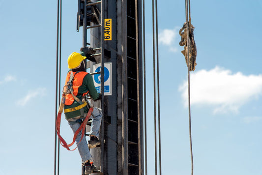 worker in fall protection gear operating from hazardous heights