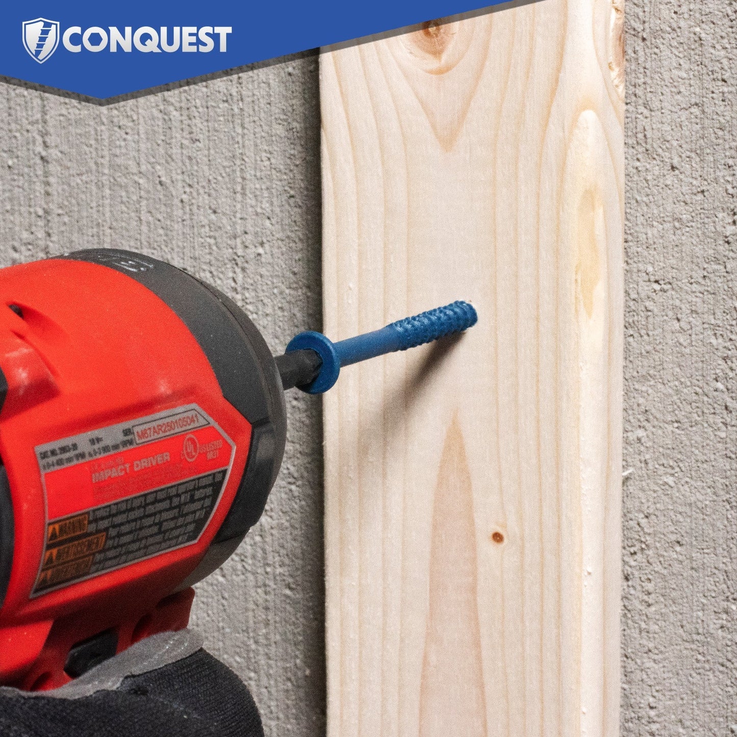 Red drill with blue concrete screw attached to a wooden board against a concrete wall, featuring the Conquest brand.