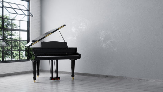 black grand piano standing up in the corner of an empty white room