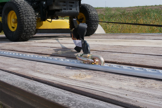 Airline style L-track being used to tie down equipment such as a lawn mower