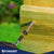 Screw being driven into a yellow wooden surface with 'Conquest' branding visible.