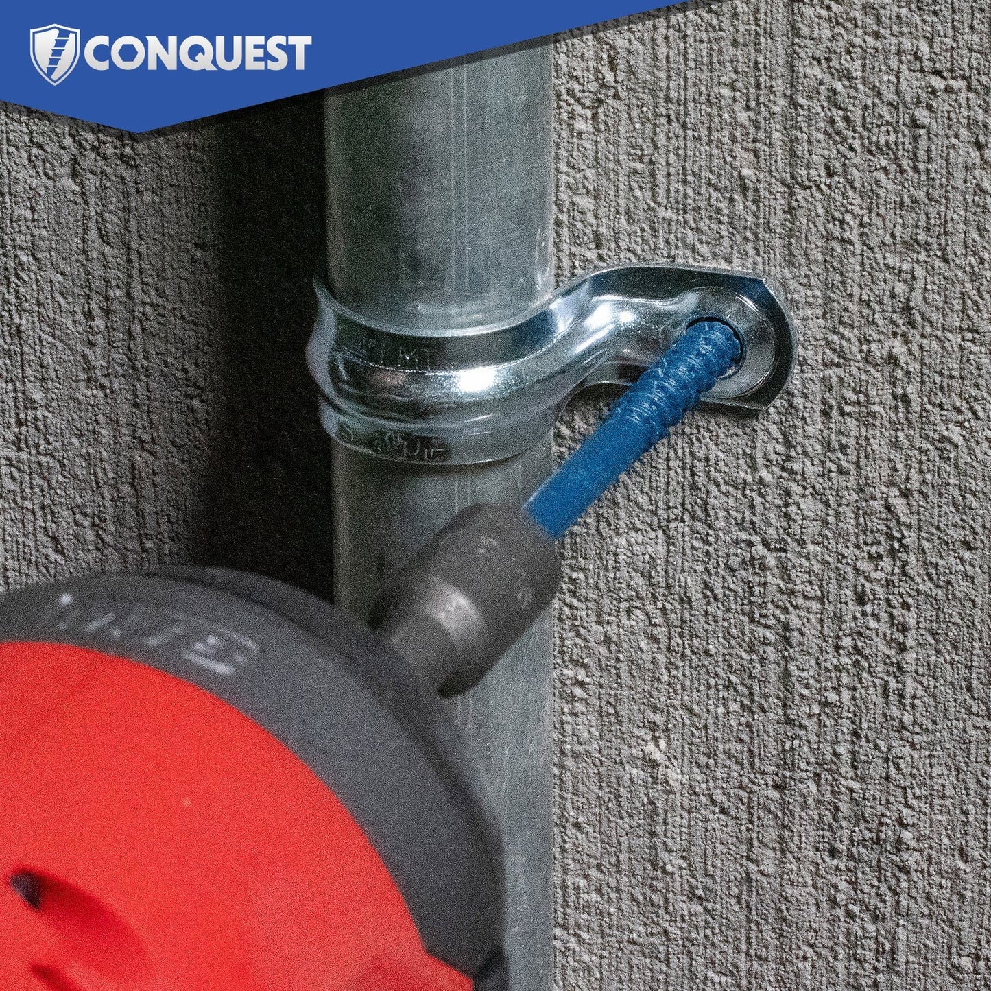 Drill screwing in blue concrete screw on a metal pipe with 'Conquest' branding in the corner.